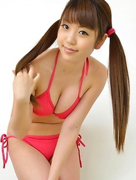 Mizuho Shiraishi with cans in pink bath suit plays with her hair