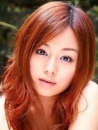 Red headed asian cutie posing in a floral printed dress