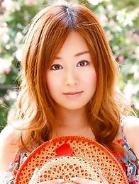 Red headed asian cutie posing in a floral printed dress