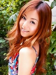 Red headed asian cutie posing in a floral printed dress