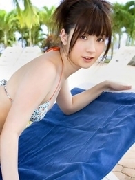 Anna Nakagawa in bath suit is playful next to the pool