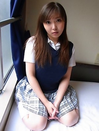 Haruka Ohsawa posing in her schoolgirl uniform and hiking up her top to show her big boobs