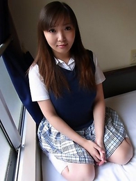 Haruka Ohsawa posing in her schoolgirl uniform and hiking up her top to show her big boobs