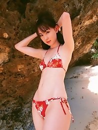 Tantilizing asian babe showing off her yummy curves at the beach