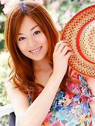 Red headed asian cutie posing in a floral printed dress